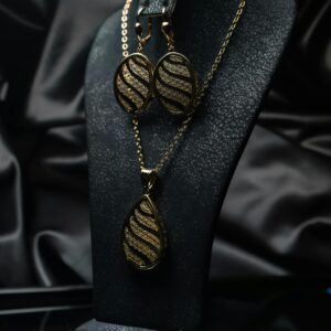 A sophisticated jewelry set featuring a necklace and earrings on a retail display.