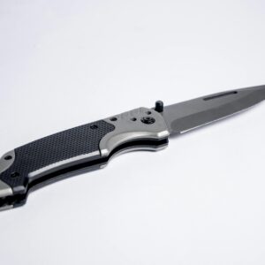 Sharp tactical folding knife with textured grip and metallic blade on white background.