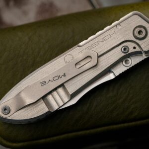 Detailed shot of a folding knife with engraved branding on a textured leather case.