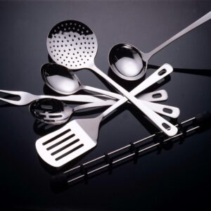 Collection of stainless steel kitchen utensils on a sleek black surface.
